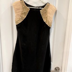 Beautiful black mini dress with cream/bedazzled sleeves!